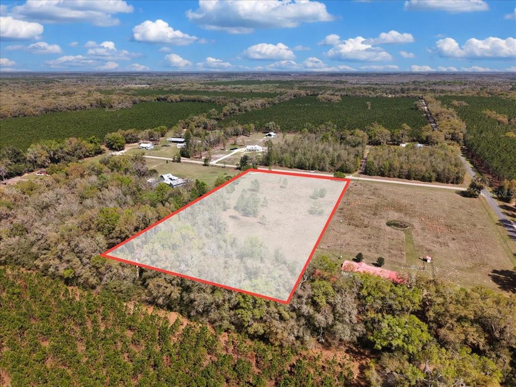 An aerial view shows a rectangular plot of land outlined in red in a rural area — 17350 NW 1ST AVENUE, TRENTON, FL