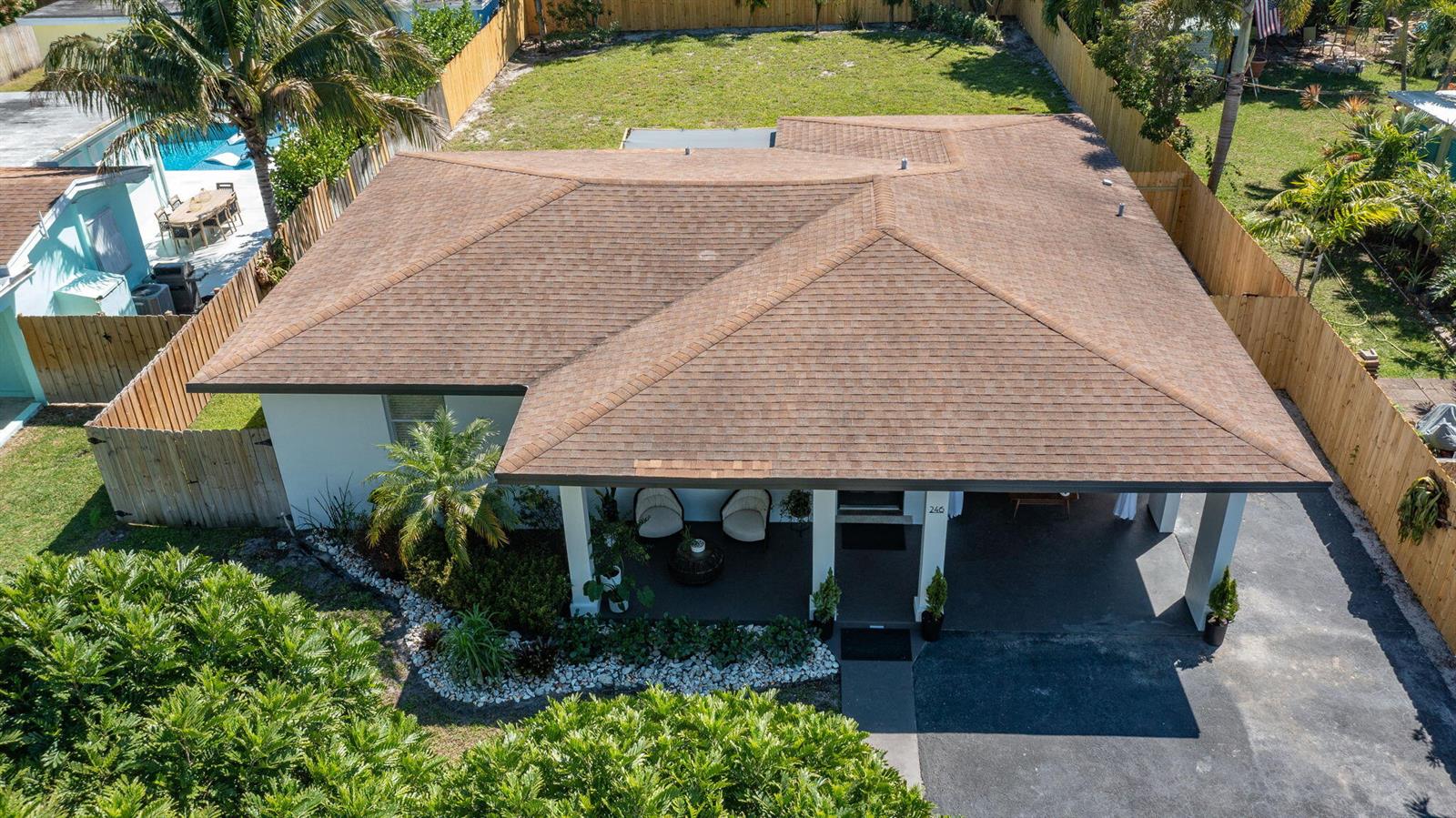 An aerial view shows a single-story house with a brown shingled roof and carport — 246 NE 14th Street, Delray Beach FL 33444, DELRAY BEACH, FL