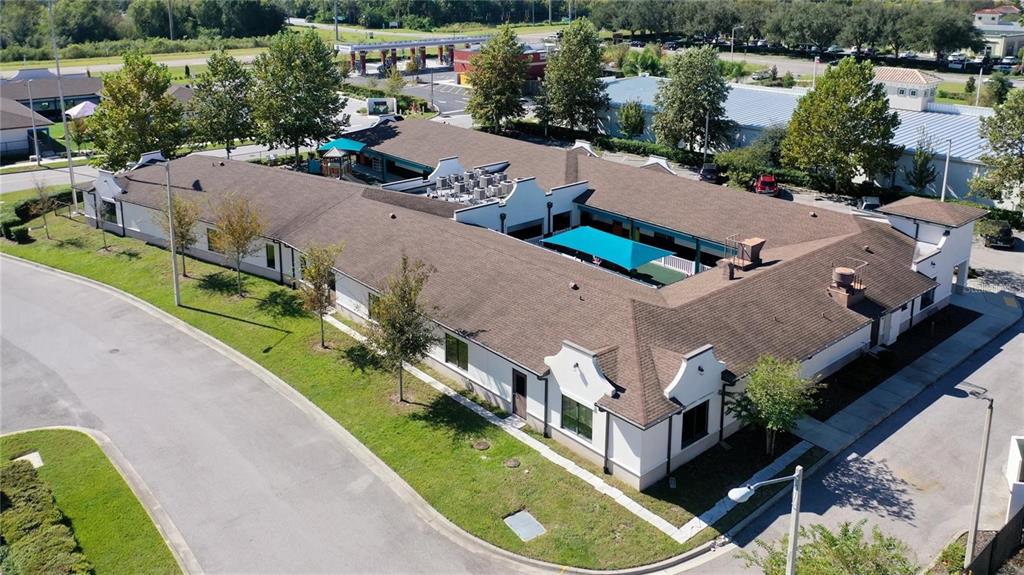 An aerial view of a single-story commercial building with a central courtyard and parking lot — 10911 FOX WOOD COMMERCE DRIVE, NEW PORT RICHEY, FL