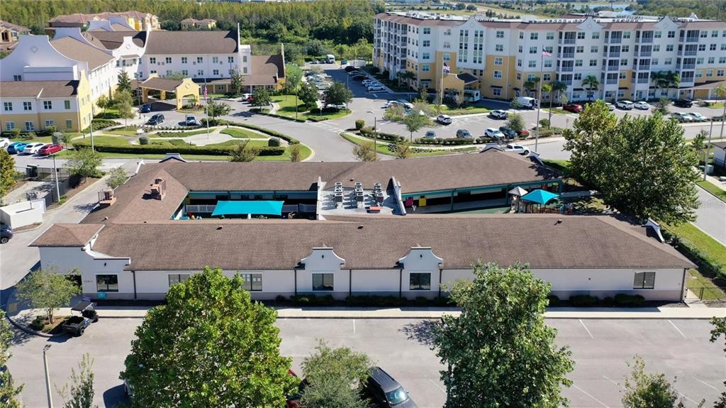 An aerial view shows a single-story commercial building with a brown roof and parking lot — 10911 FOX WOOD COMMERCE DRIVE, NEW PORT RICHEY, FL