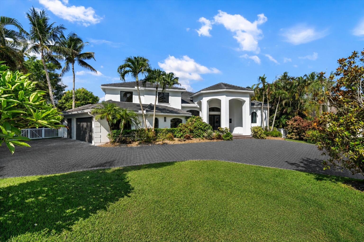 A two-story white house with a dark-tiled roof and a large paved driveway — 15463 Tall Oak Avenue, Delray Beach FL 33446, DELRAY BEACH, FL