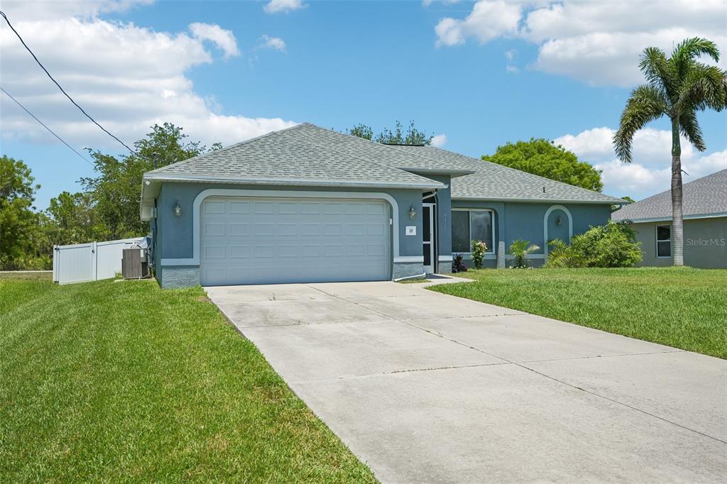 A single-story house with a gray exterior, a two-car garage, and a concrete driveway — 4317 NW 40TH TERRACE, CAPE CORAL, FL