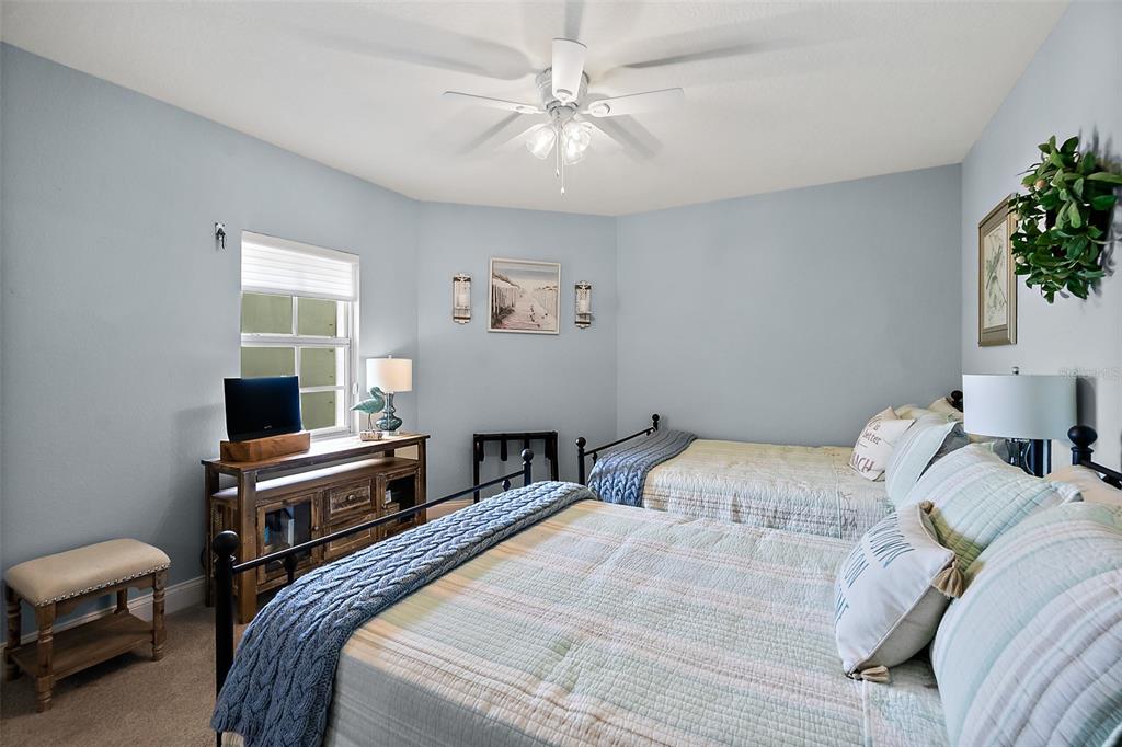 A dining and living area with hardwood floors, a gray accent wall, and ocean views — 3145 S ATLANTIC AVENUE UNIT 504, DAYTONA BEACH SHORES, FL