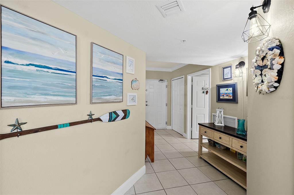 A living and dining area with hardwood floors, a balcony, and ocean views — 3145 S ATLANTIC AVENUE UNIT 504, DAYTONA BEACH SHORES, FL
