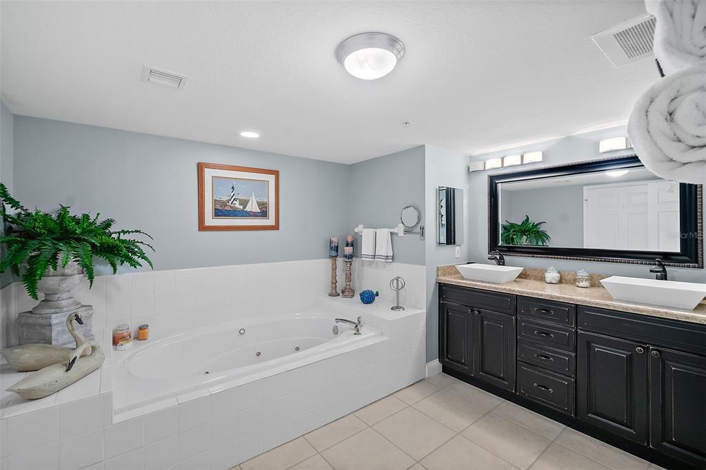 A living room features a television, fireplace console, coffee table, and sliding doors overlooking the ocean — 3145 S ATLANTIC AVENUE UNIT 504, DAYTONA BEACH SHORES, FL