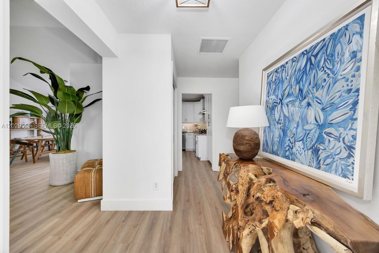 A single-story house with white stucco walls, blue shutters, and a stone-accented entryway — 17107 N 84th Ct N, Loxahatchee FL 33470, LOXAHATCHEE, FL