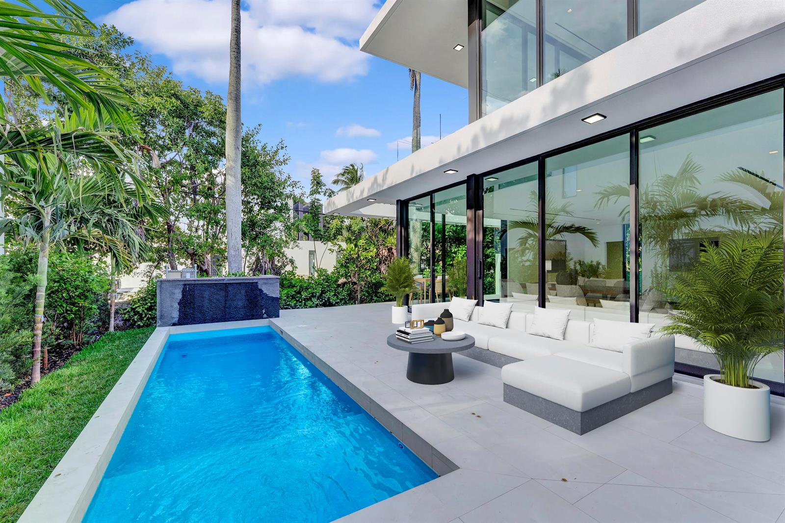 A modern house features a rectangular swimming pool and a white sectional sofa on a patio — 2130 S Miami Avenue, Miami FL 33129, MIAMI, FL