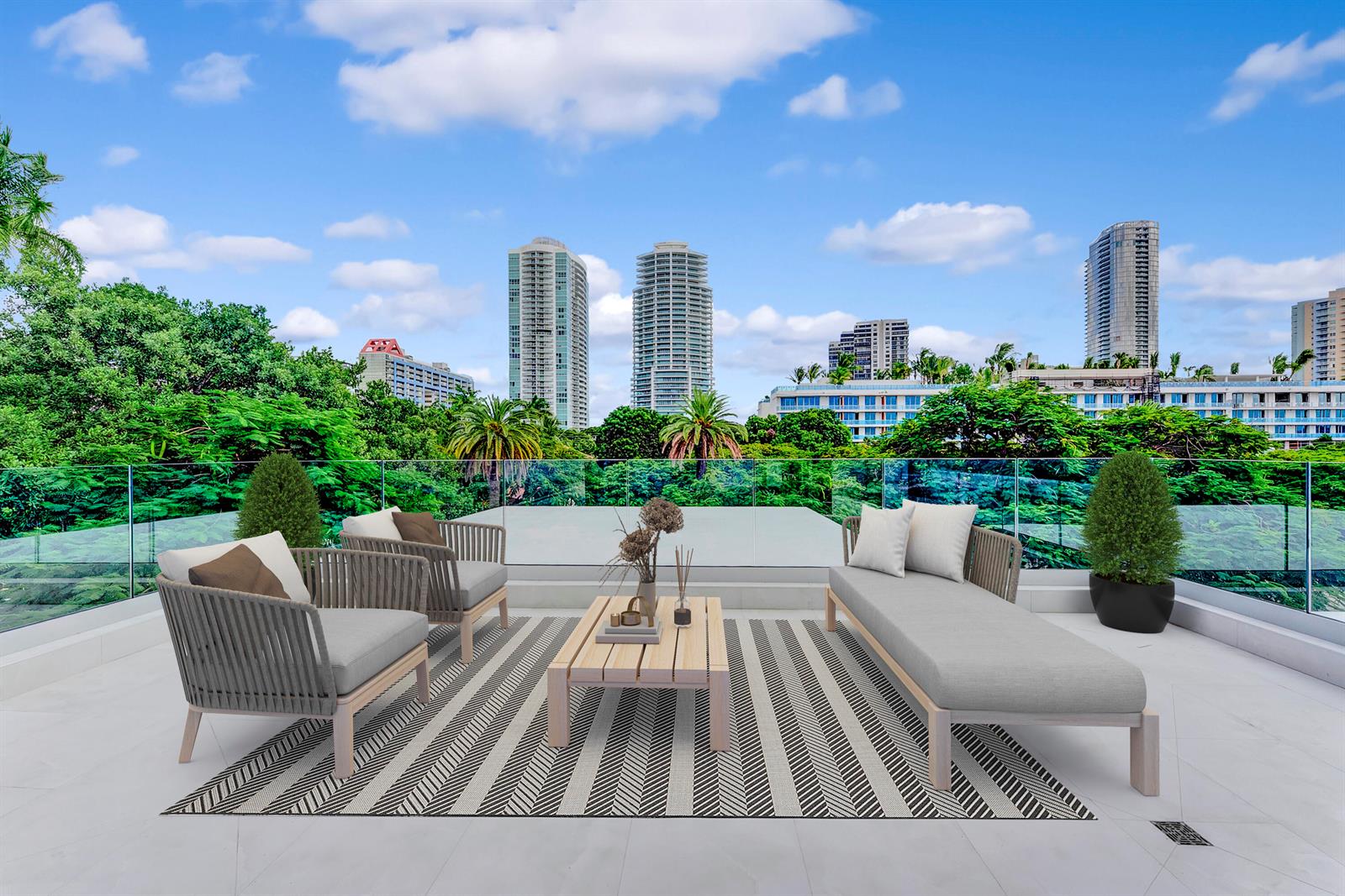 A modern outdoor terrace features patio furniture on a striped rug overlooking a city skyline — 2130 S Miami Avenue, Miami FL 33129, MIAMI, FL
