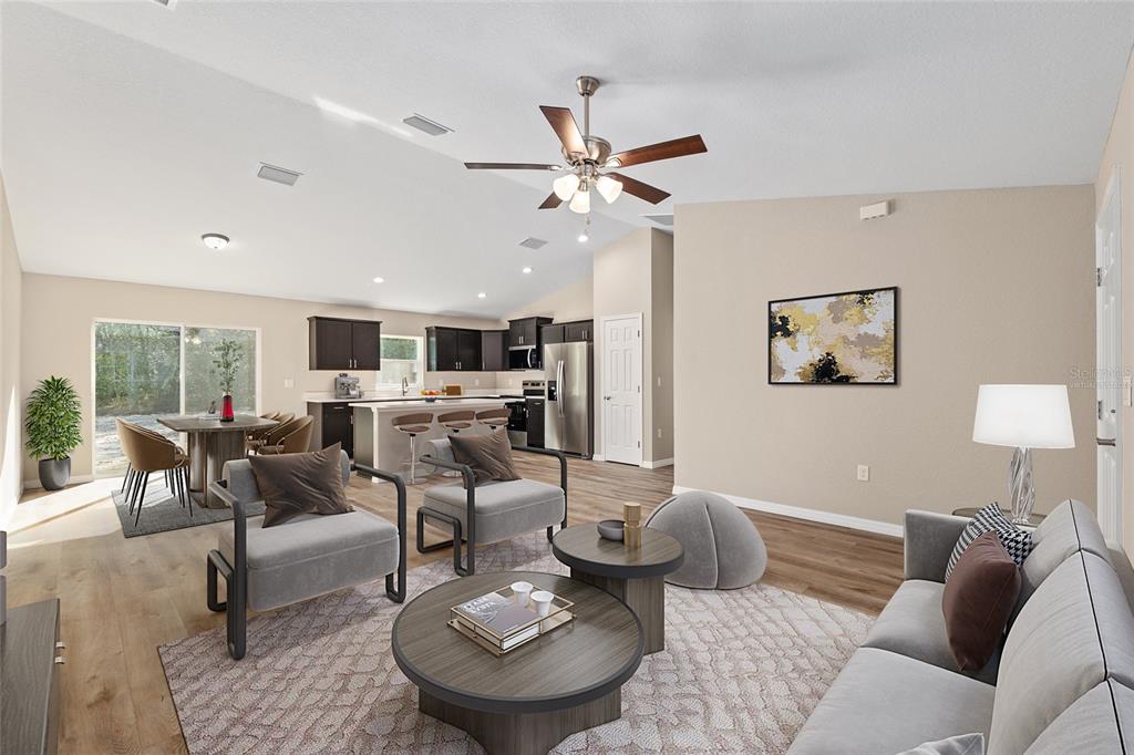 This is a virtual rendering of an open-concept living room and kitchen with wood flooring — 8442 N TEMPEST DRIVE, CITRUS SPRINGS, FL