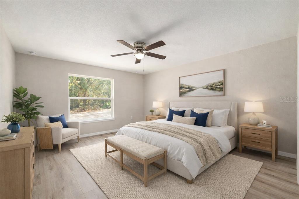 This is a virtually staged bedroom featuring a king bed, neutral decor, and wood flooring — 8442 N TEMPEST DRIVE, CITRUS SPRINGS, FL