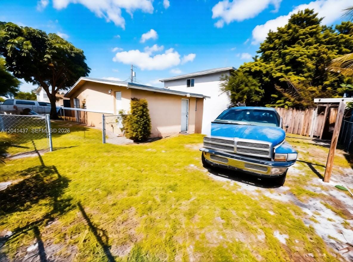A blue pickup truck is parked on the lawn in front of a house — 1896 NW 64th St # 1, Miami FL 33147, MIAMI, FL