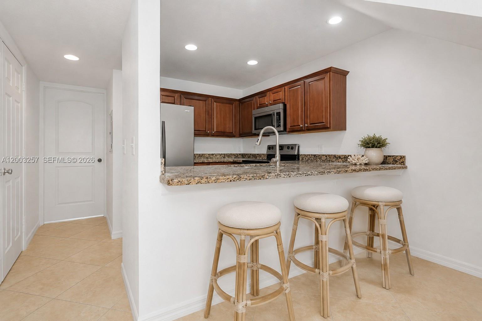A living room features a beige sofa, two armchairs, a coffee table, and a kitchen — 1000 Palm Trl # 6, Delray Beach FL 33483, DELRAY BEACH, FL