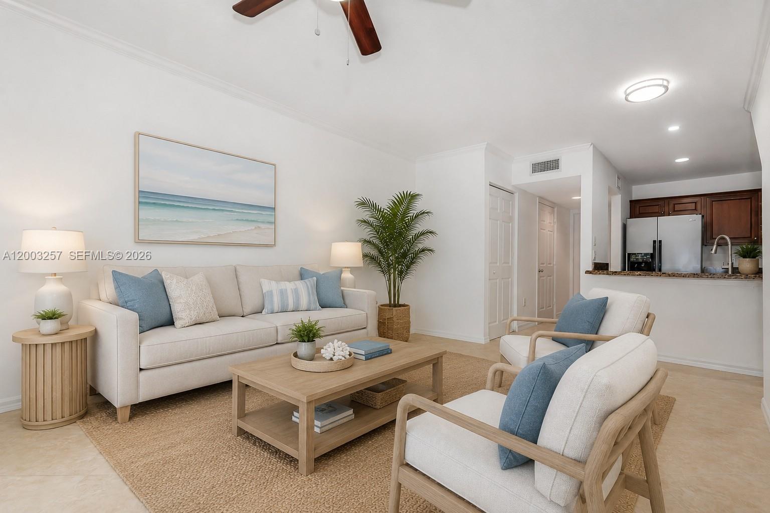 An open-concept living area features tile flooring, a ceiling fan, and an adjacent kitchen — 1000 Palm Trl # 6, Delray Beach FL 33483, DELRAY BEACH, FL