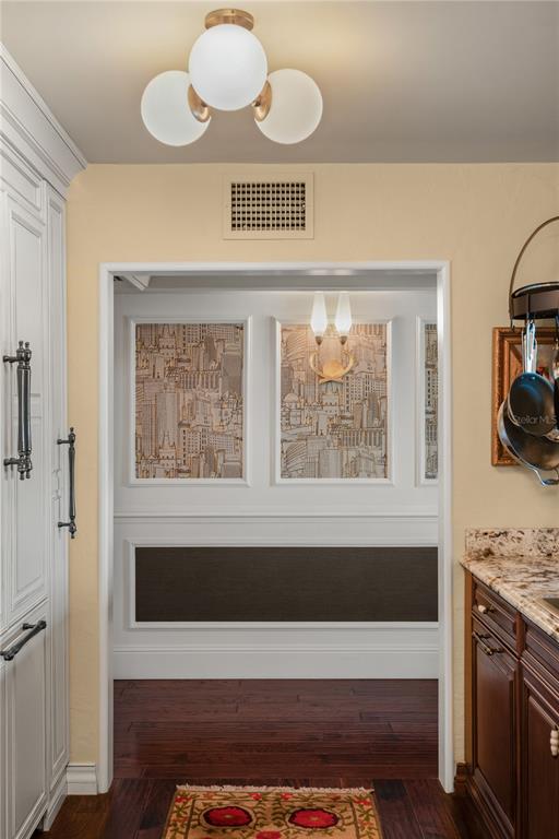 A view through a doorway shows a hallway with city-themed wallpaper and wood flooring — 269 E CANTON AVENUE UNIT 269, WINTER PARK, FL