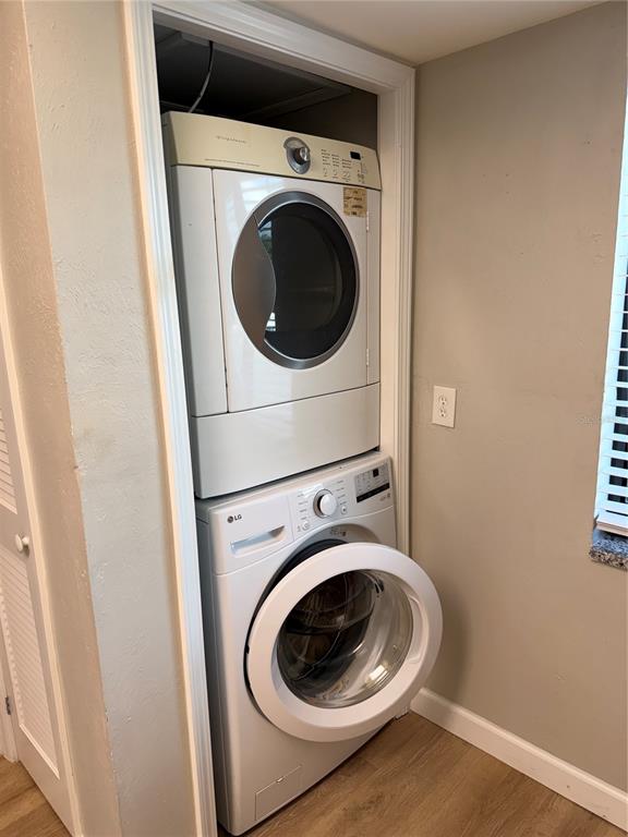 A stacked washer and dryer unit is installed in a small laundry closet — 4711 SANTA BARBARA BOULEVARD UNIT 1, CAPE CORAL, FL