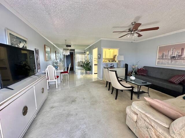 A living room features a television, a sofa, dining chairs, and a ceiling fan — 30 Suffolk A, Boca Raton FL 33434, BOCA RATON, FL