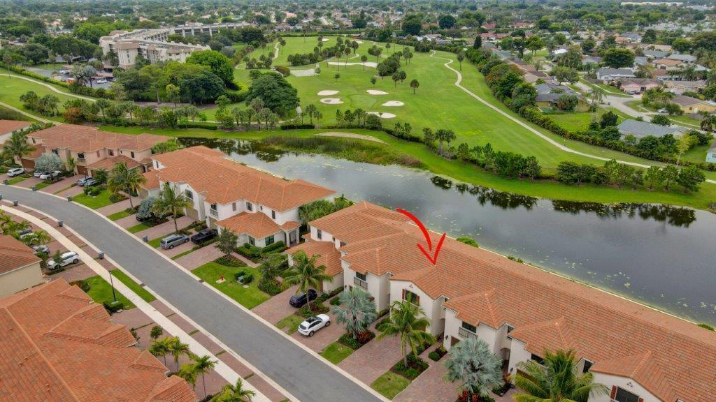 An aerial view shows a multi-unit townhouse complex with red tile roofs beside a pond — 10102 Akenside Drive, Boca Raton FL 33428, BOCA RATON, FL