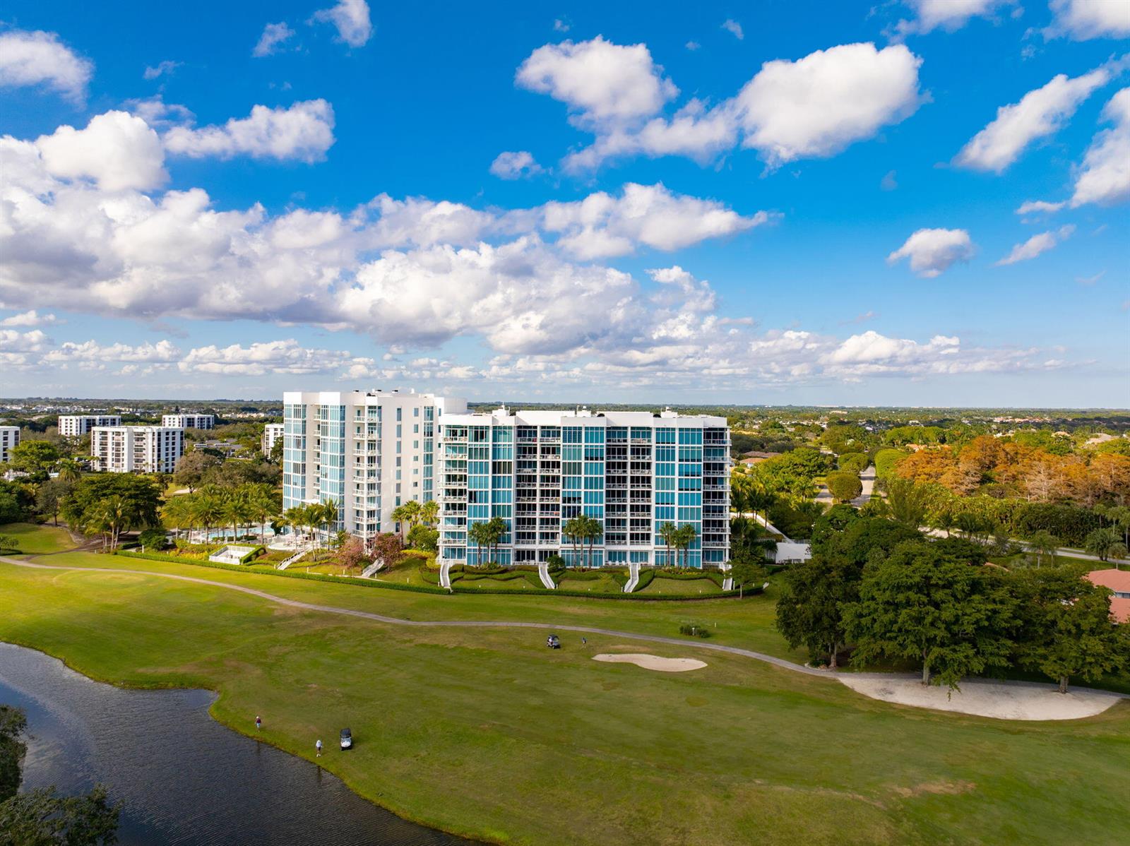 An aerial view of a multi-story apartment complex situated next to a golf course — 20155 Boca West Drive # A404, Boca Raton FL 33434, BOCA RATON, FL