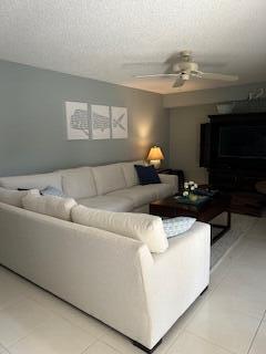 A living room features a large white sectional sofa, a coffee table, and wall art — 3017 30th Court, Jupiter FL 33477, JUPITER, FL