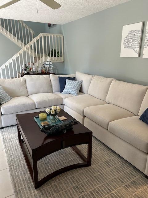 A living room features a large beige sectional sofa, a dark wood coffee table, and stairs — 3017 30th Court, Jupiter FL 33477, JUPITER, FL