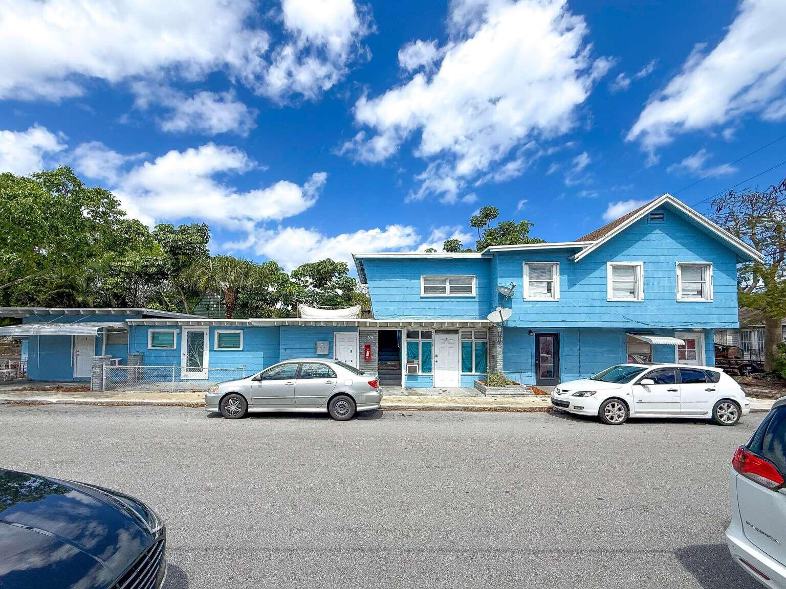 A two-story blue building with a flat-roofed extension and two cars parked in front — 714 N 4th Ave Avenue N, FL 33460, FL