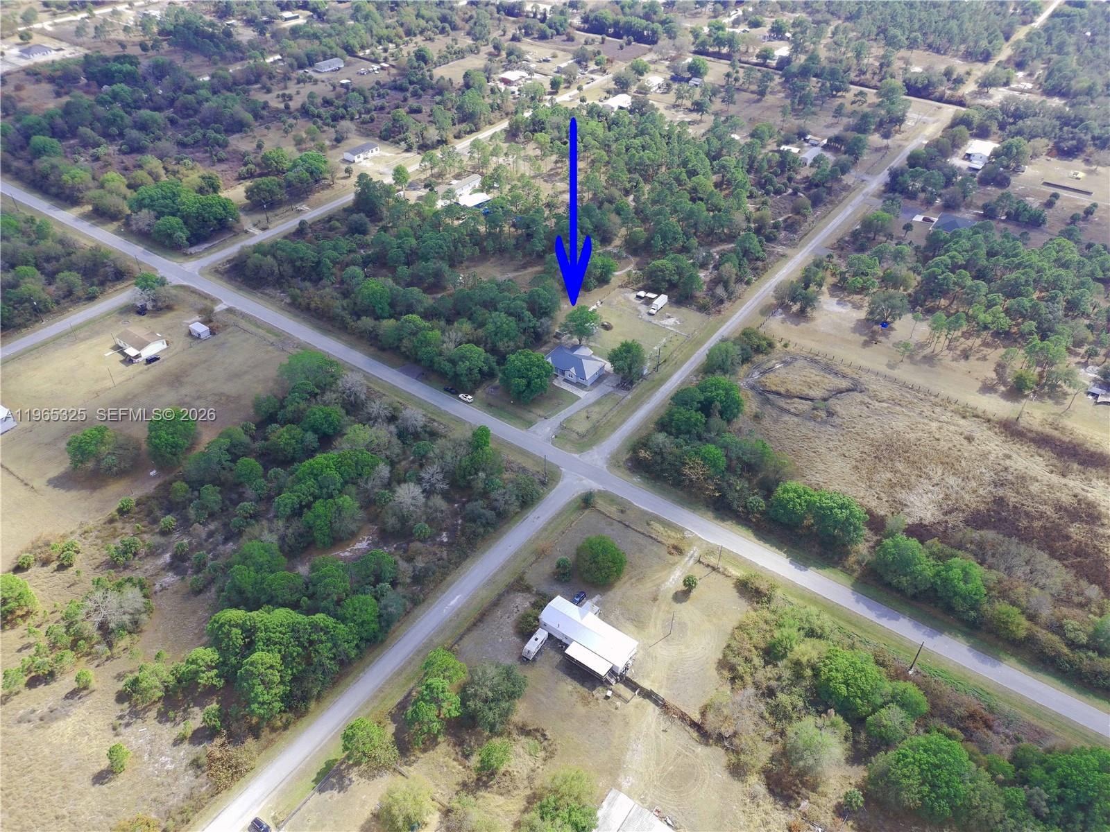 An aerial view shows a house situated on a rural lot near a road intersection — 548 Bald Cypress Ave, Clewiston FL 33440, CLEWISTON, FL