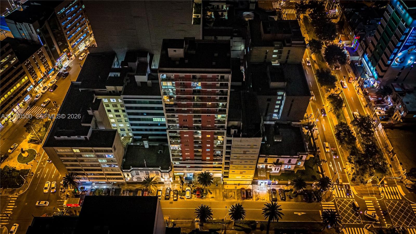An aerial night view shows a city street with a tall apartment building and traffic — 175 Jiron Saco Oliveros PE # 1903, PE 0000, PE