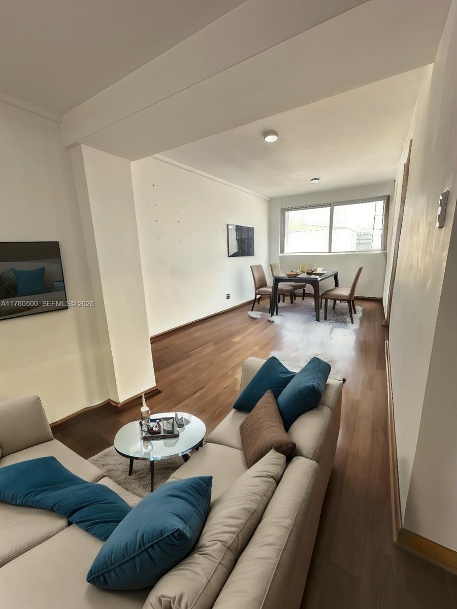 A living and dining area features light-colored sofas, a glass coffee table, and wood flooring — 175 Jiron Saco Oliveros PE # 1903, PE 0000, PE