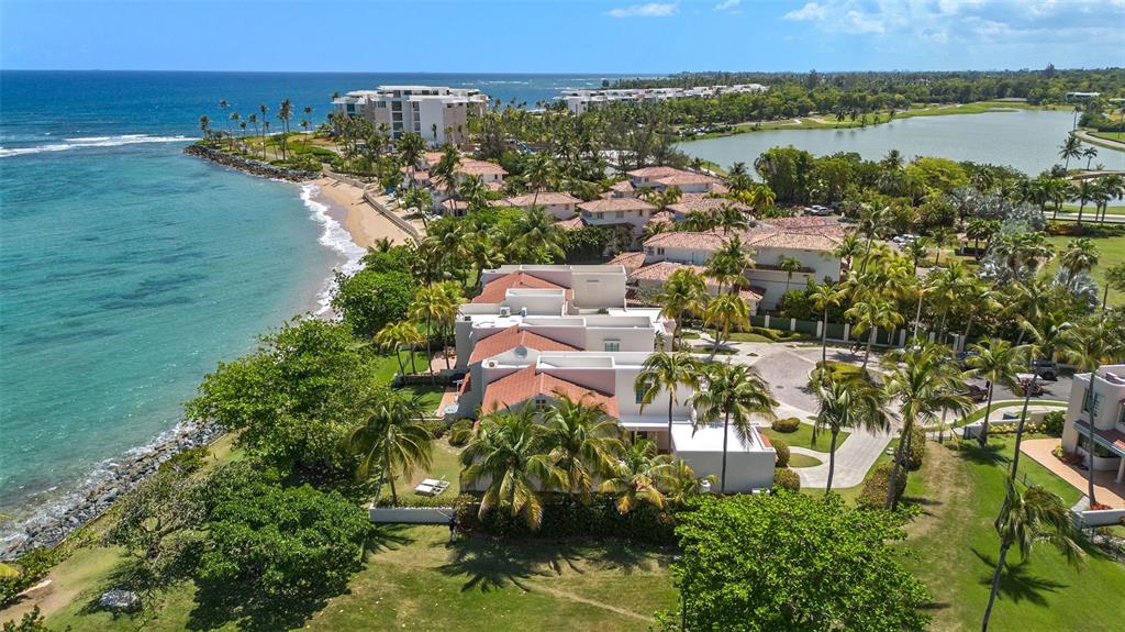 An aerial view of a multi-unit residential building with white stucco walls and tiled roofs — 57 DORADO REEF, DORADO, PR