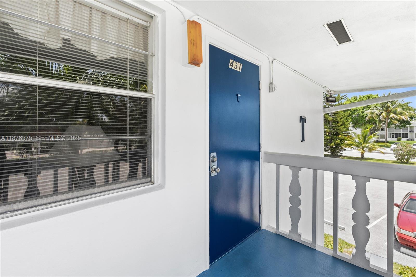 A blue front door with the number 431 is situated on a white exterior walkway — 431 Markham T # 431, Deerfield Beach FL 33442, DEERFIELD BEACH, FL