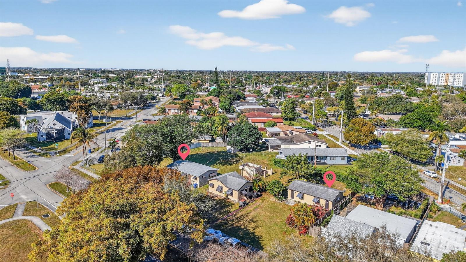 An aerial view shows three small residential houses situated on a large, grassy lot — 411 Columbus Parkway # 5, Hollywood FL 33021, HOLLYWOOD, FL