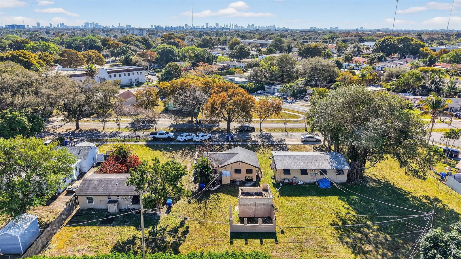 An aerial view shows several small houses and a concrete structure on a grassy lot — 411 Columbus Parkway # 5, Hollywood FL 33021, HOLLYWOOD, FL