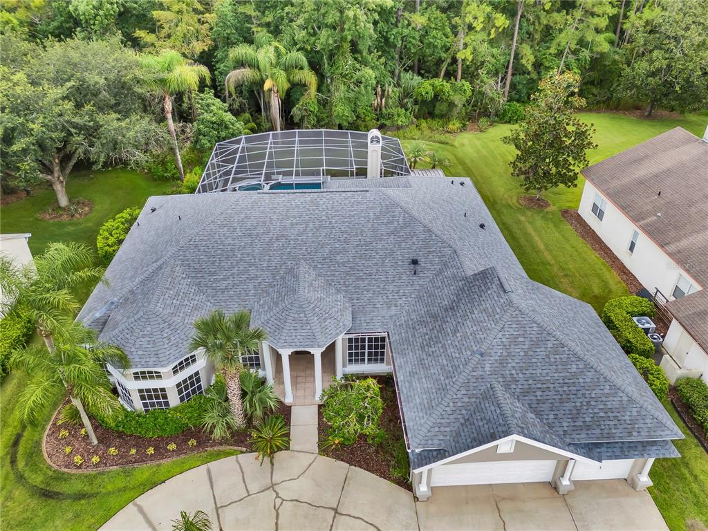 An aerial view shows a single-story house with a shingled roof and a screened pool — 4749 SUDBURY DRIVE, ORLANDO, FL