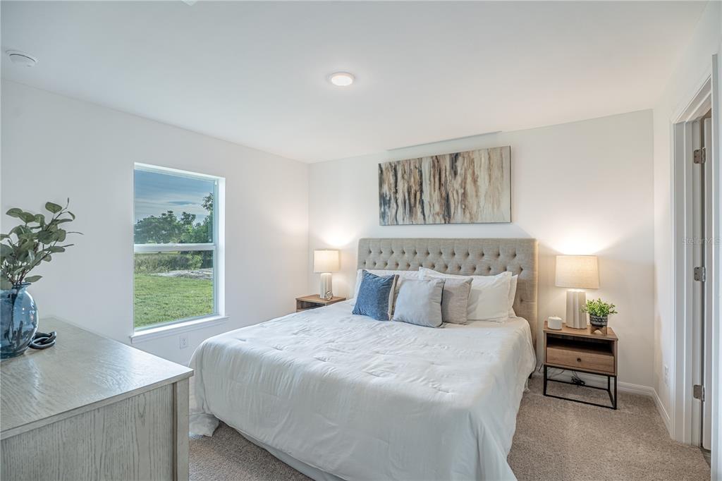 A bedroom features a tufted headboard, two nightstands, a window, and a dresser — 364 LINDON STREET, PORT CHARLOTTE, FL