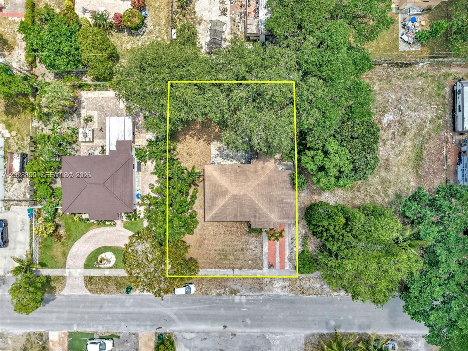 An aerial view shows a single-story house with a brown roof on a grassy lot — 130 NE 171st Ter, Miami FL 33162, MIAMI, FL