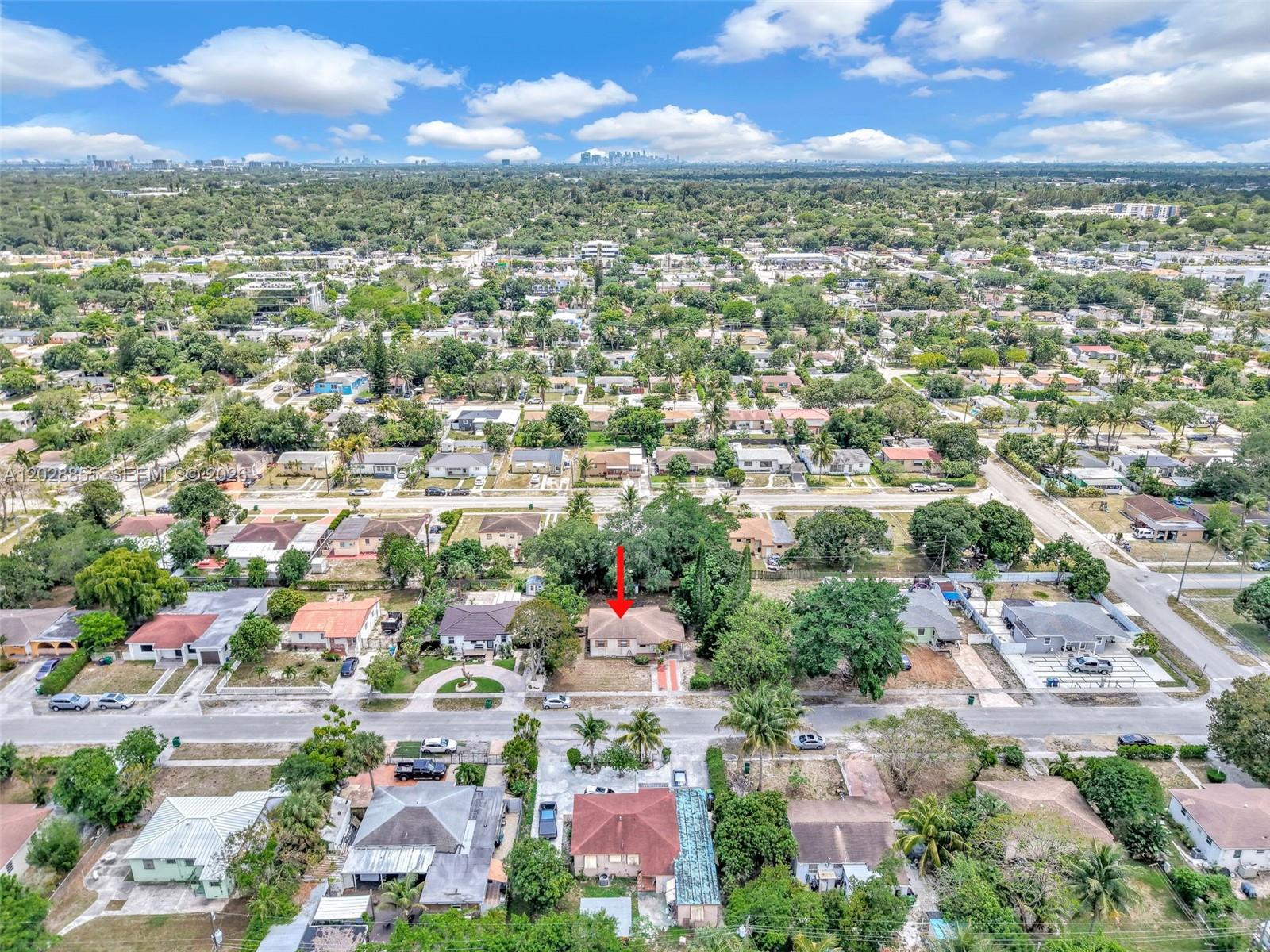 An aerial view shows a single-story house with a red arrow pointing to its roof — 130 NE 171st Ter, Miami FL 33162, MIAMI, FL