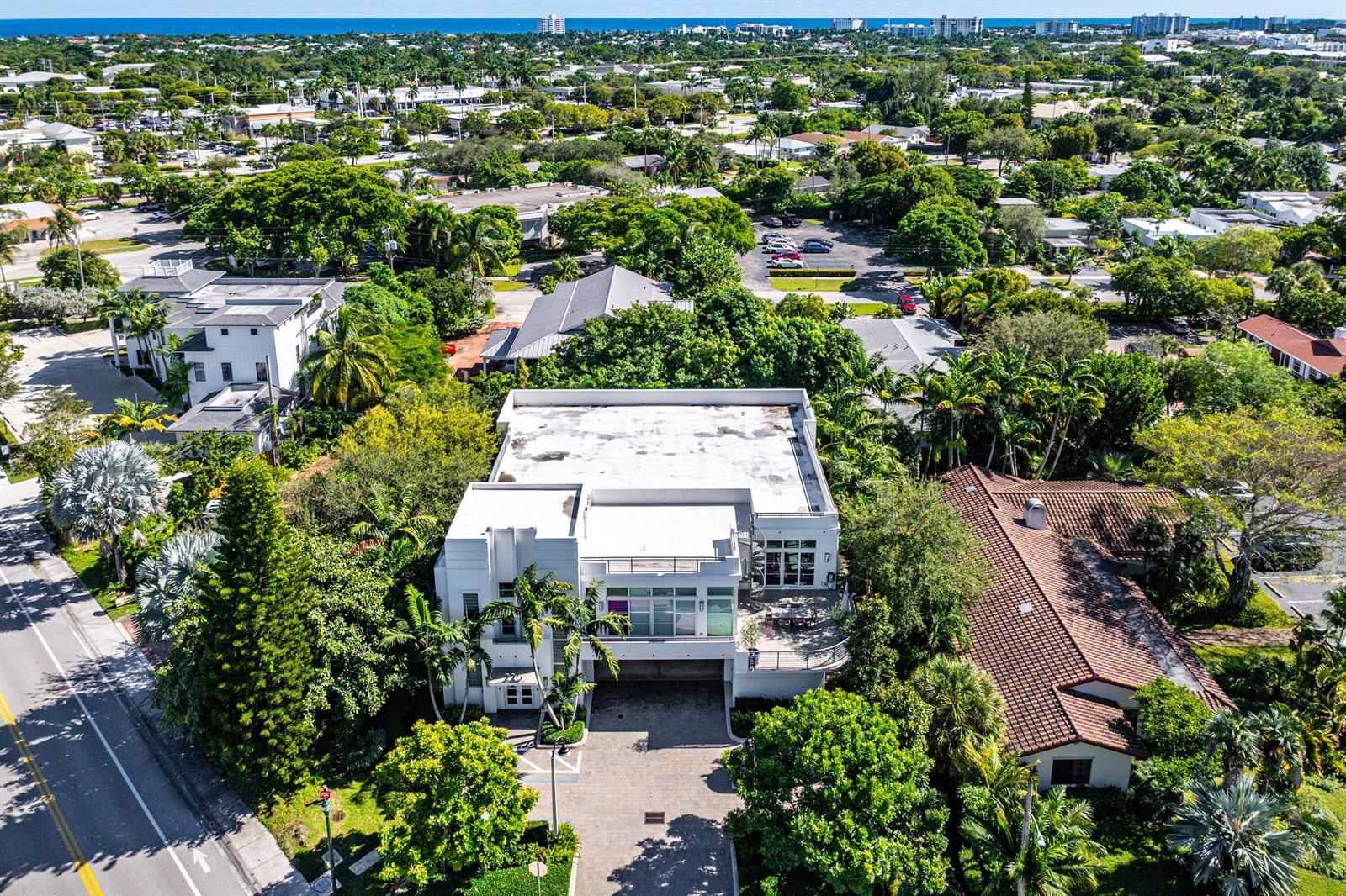 An aerial view of a modern white two-story building with a flat roof and driveway — 226 Palm Court, Delray Beach FL 33444, DELRAY BEACH, FL