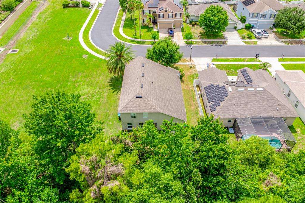 An aerial view shows two suburban houses with solar panels and a backyard swimming pool — 403 CAREY WAY, ORLANDO, FL
