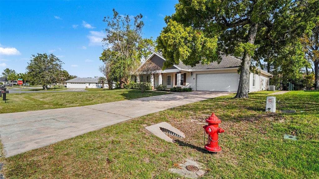 A single-story house with a white garage and a red fire hydrant in the yard — 5427 SW 87TH PLACE, OCALA, FL