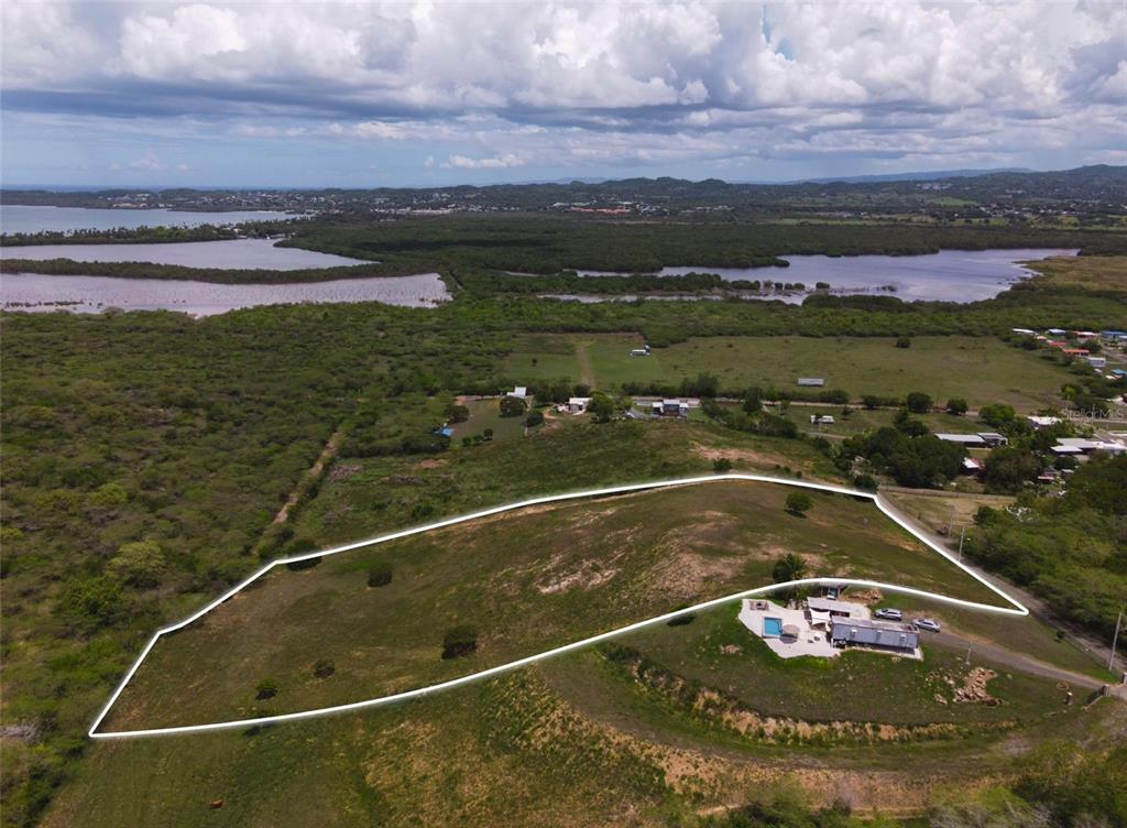 An aerial view shows a large, grassy lot with a house and pool outlined in white — Carr 301 km 3.2 MONTELCARLO STATE, CABO ROJO, PR