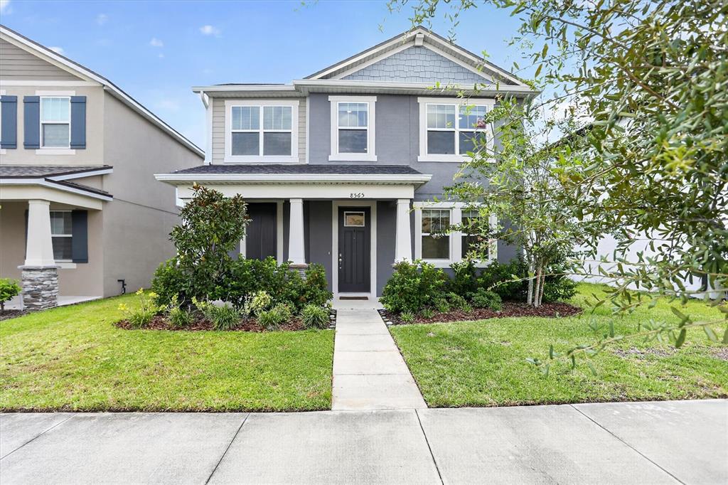 A two-story gray house with a front porch and a concrete walkway — 8565 LAMPPOST LANE, ORLANDO, FL