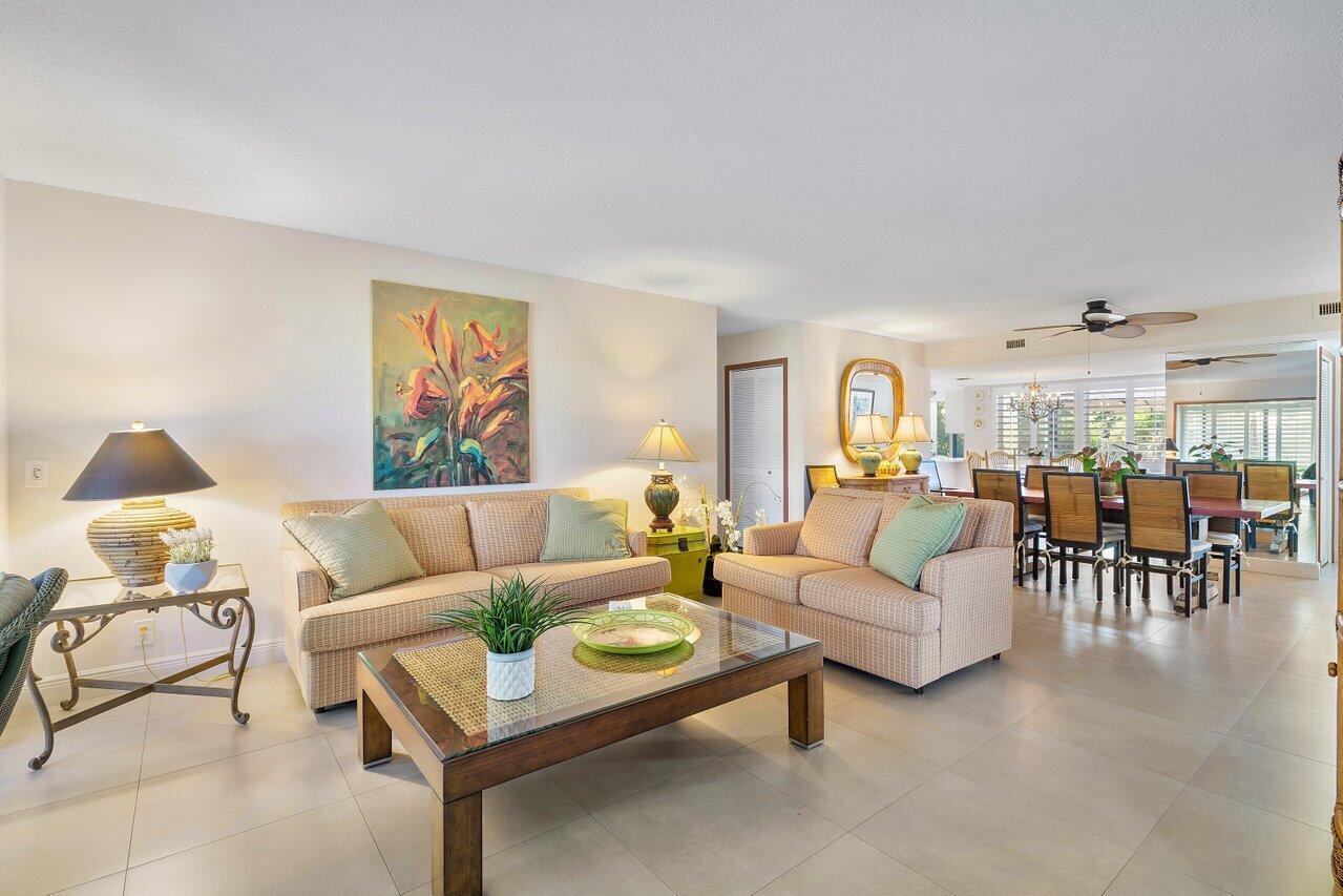 A living room features beige sofas, a glass-topped coffee table, and a dining area beyond — 3677 Quail Ridge Drive # B, Boynton Beach FL 33436, BOYNTON BEACH, FL