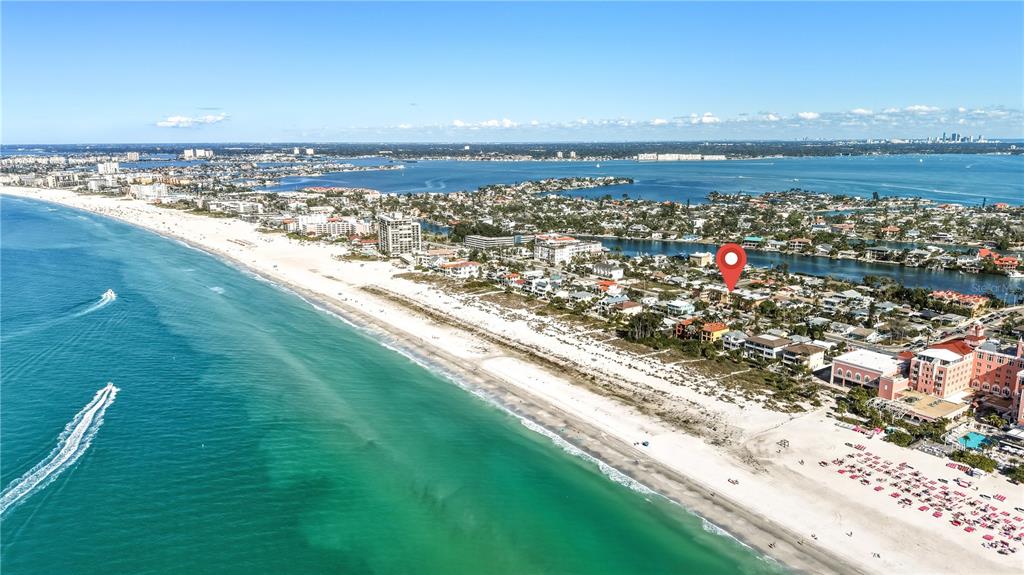 An aerial view shows a sandy beach, turquoise water, and coastal buildings with a location marker — 3575 GULF BOULEVARD UNIT 105, ST PETE BEACH, FL
