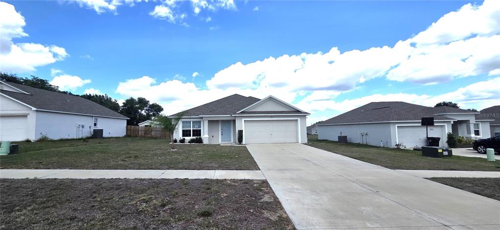 A single-story suburban house with a two-car garage and a concrete driveway — 170 W 6TH STREET, FROSTPROOF, FL