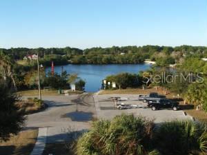 An aerial view of a boat ramp and parking area next to a lake — 5080 MONTEGO LANE, PORT CHARLOTTE, FL