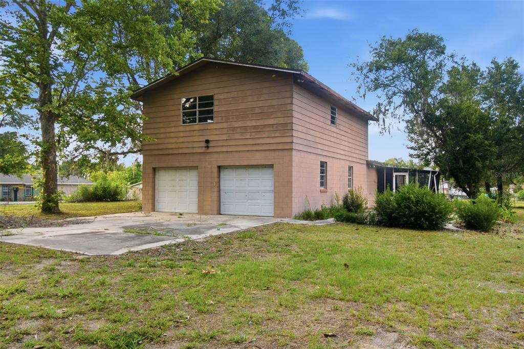 A two-story detached garage with a concrete block lower level and wood siding above — 2805 NE 24TH COURT, OCALA, FL