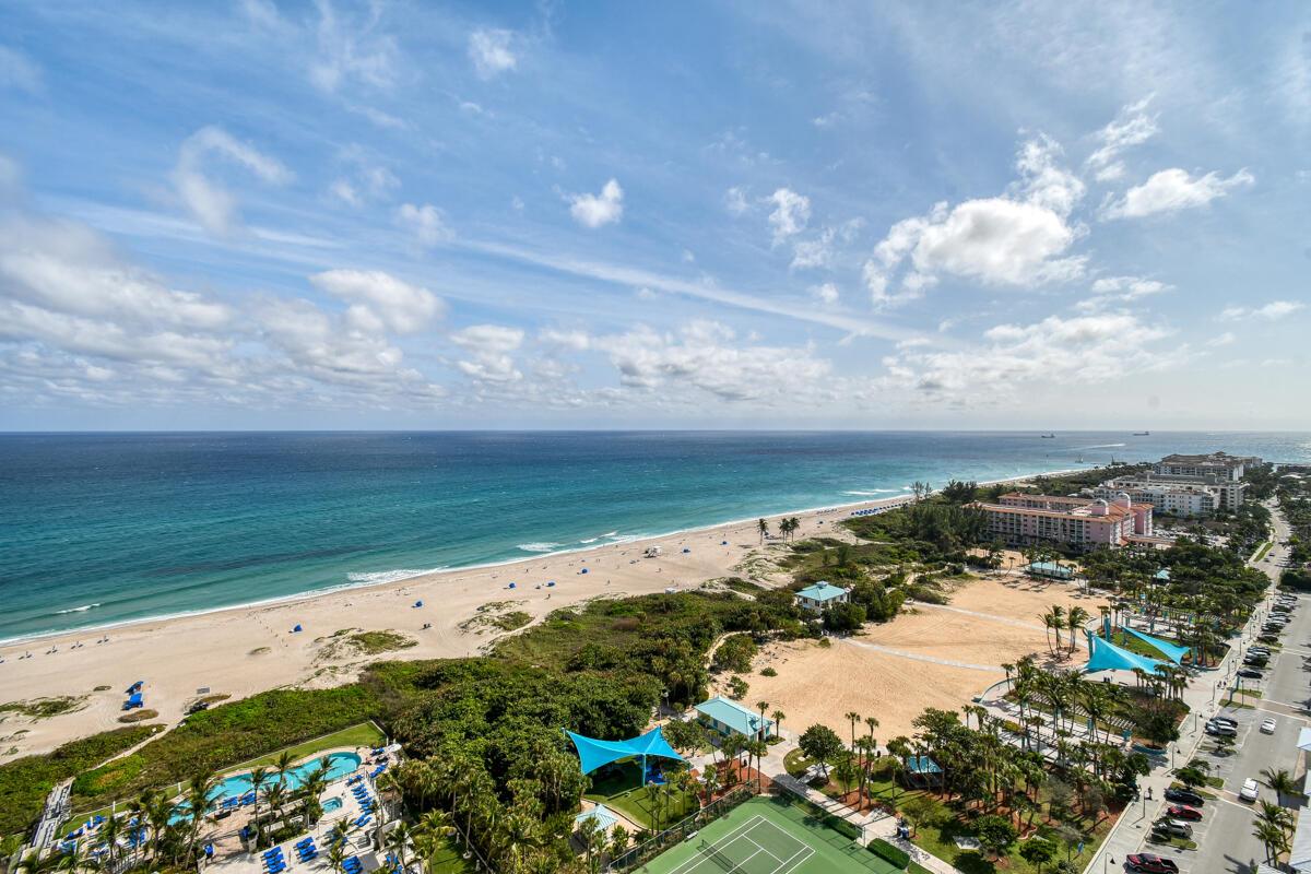 An aerial view of a beach, ocean, resort buildings, and a tennis court — 2700 N Ocean Drive # 2003b, Singer Island FL 33404, SINGER ISLAND, FL