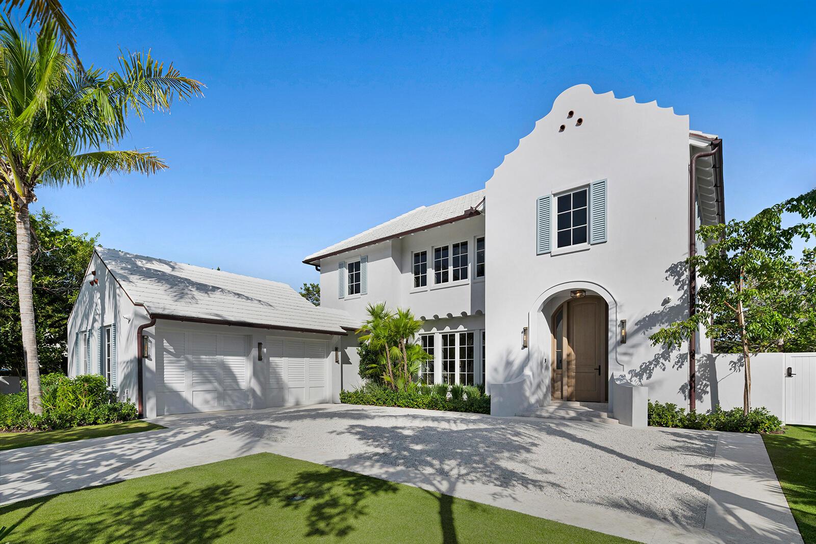 A white two-story house with a curved gable, arched entryway, and attached two-car garage — 2219 Ibis Isle Road E, Palm Beach FL 33480, PALM BEACH, FL