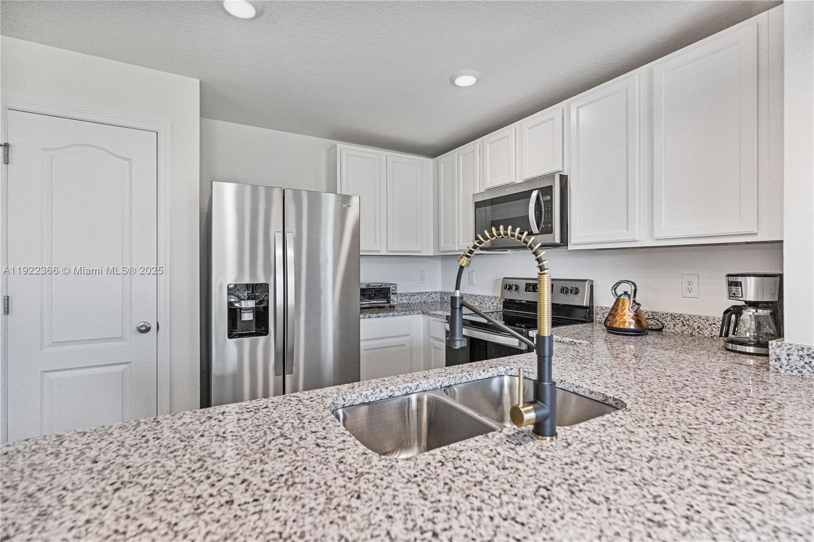 Kitchen with Granite Countertops and Stainless Appliances — SAINT CLOUD, FL
