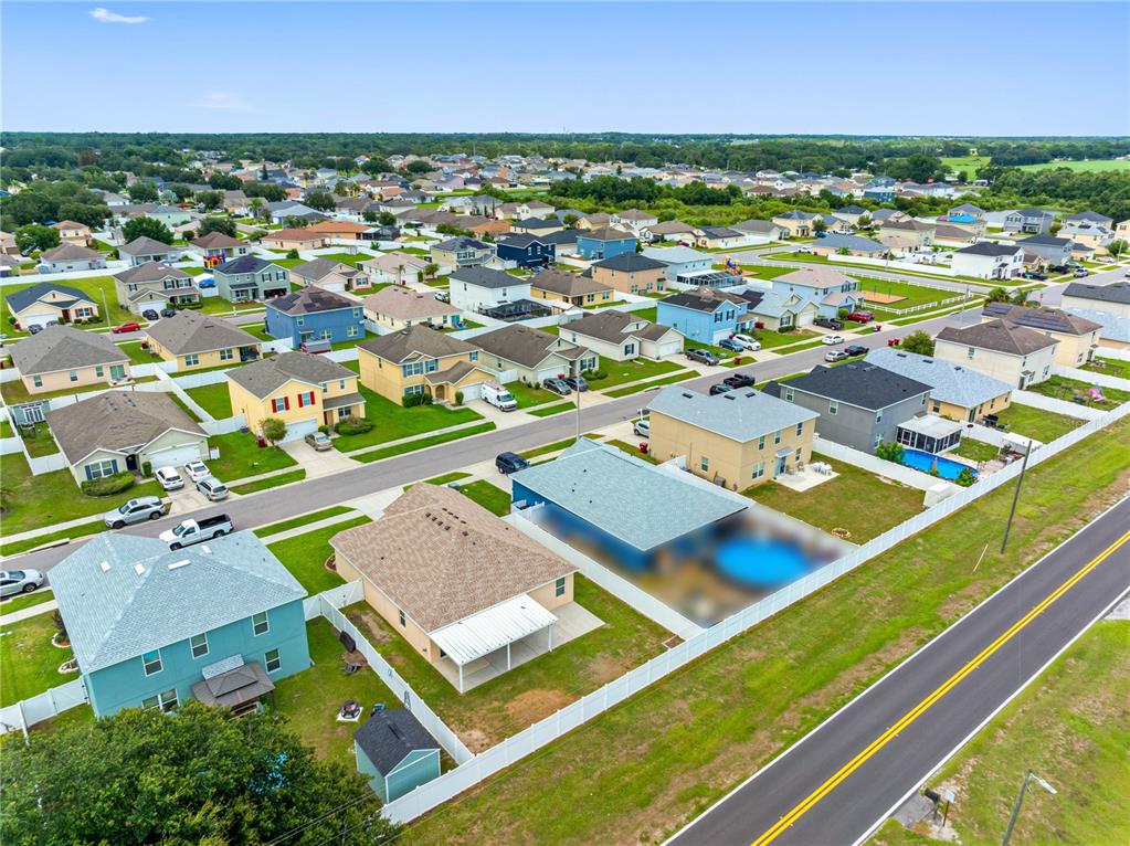 A tan single-story house with a two-car garage, a front lawn, and a white fence — 3518 SAN MOISE PLACE, PLANT CITY, FL